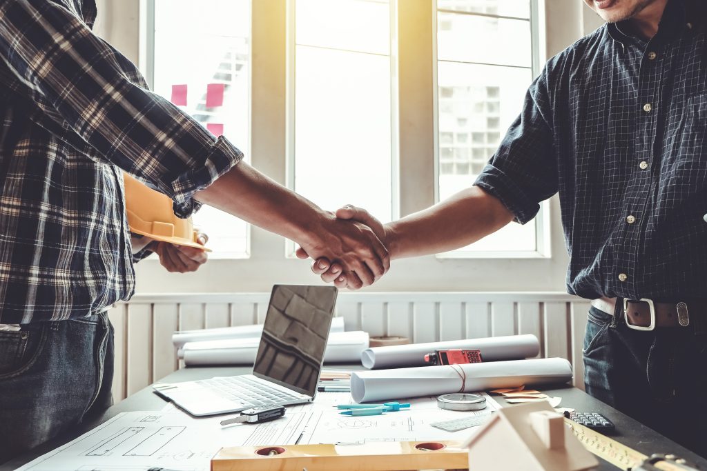 Engineer and contractor shaking hands success of the project wor