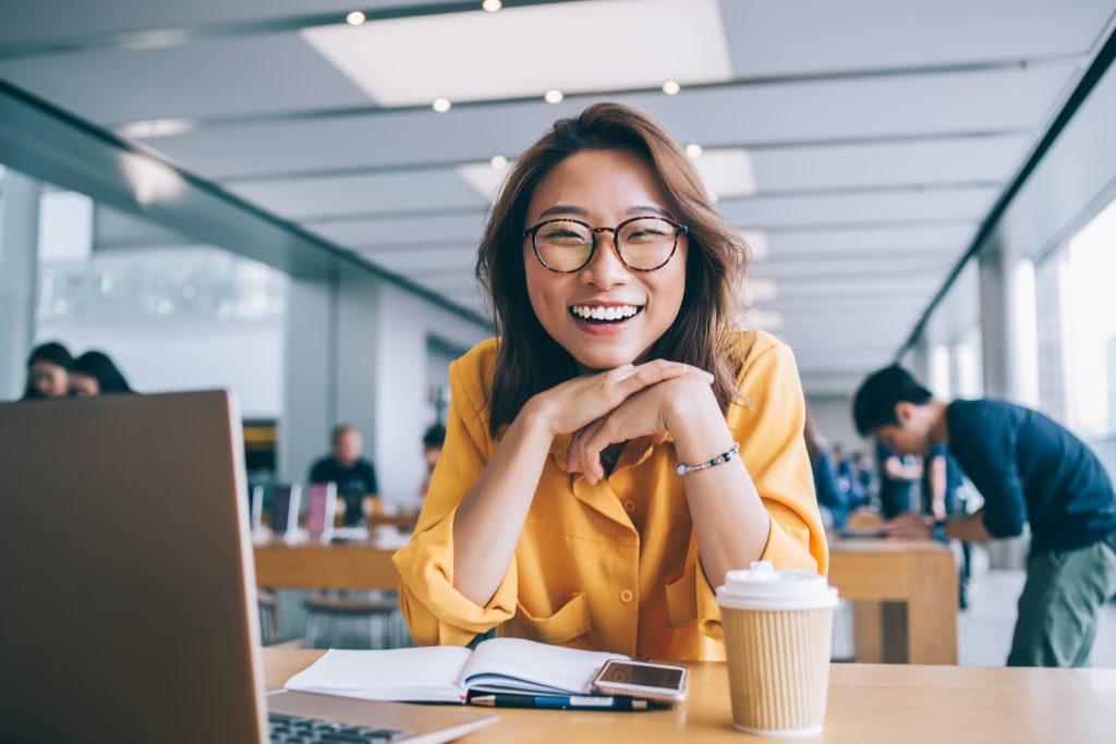 Cheerful female freelancer in workspace