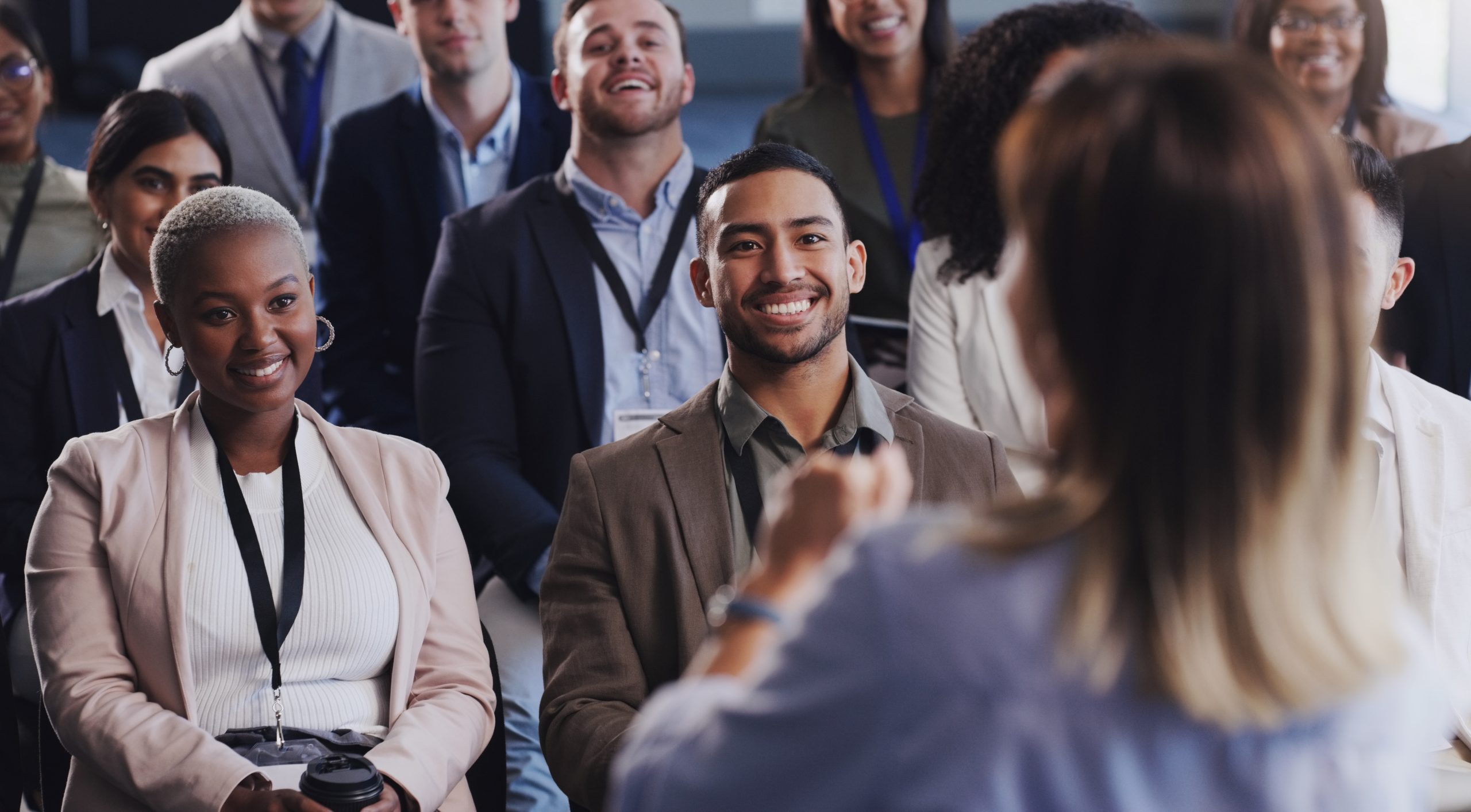 Audience, conference and business people listening to speaker at a seminar, workshop or training. Diversity men and women crowd at a presentation for learning, knowledge and corporate discussion.